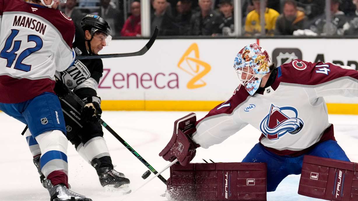 Los Angeles Kings left wing Trevor Moore, center, scores on goaltender Scott Wedgewood, right, as defenseman Josh Manson defends during the second period of Game 3 in the first round of the NHL hockey Stanley Cup playoffs Thursday, April 23, 2026, in Los Angeles.