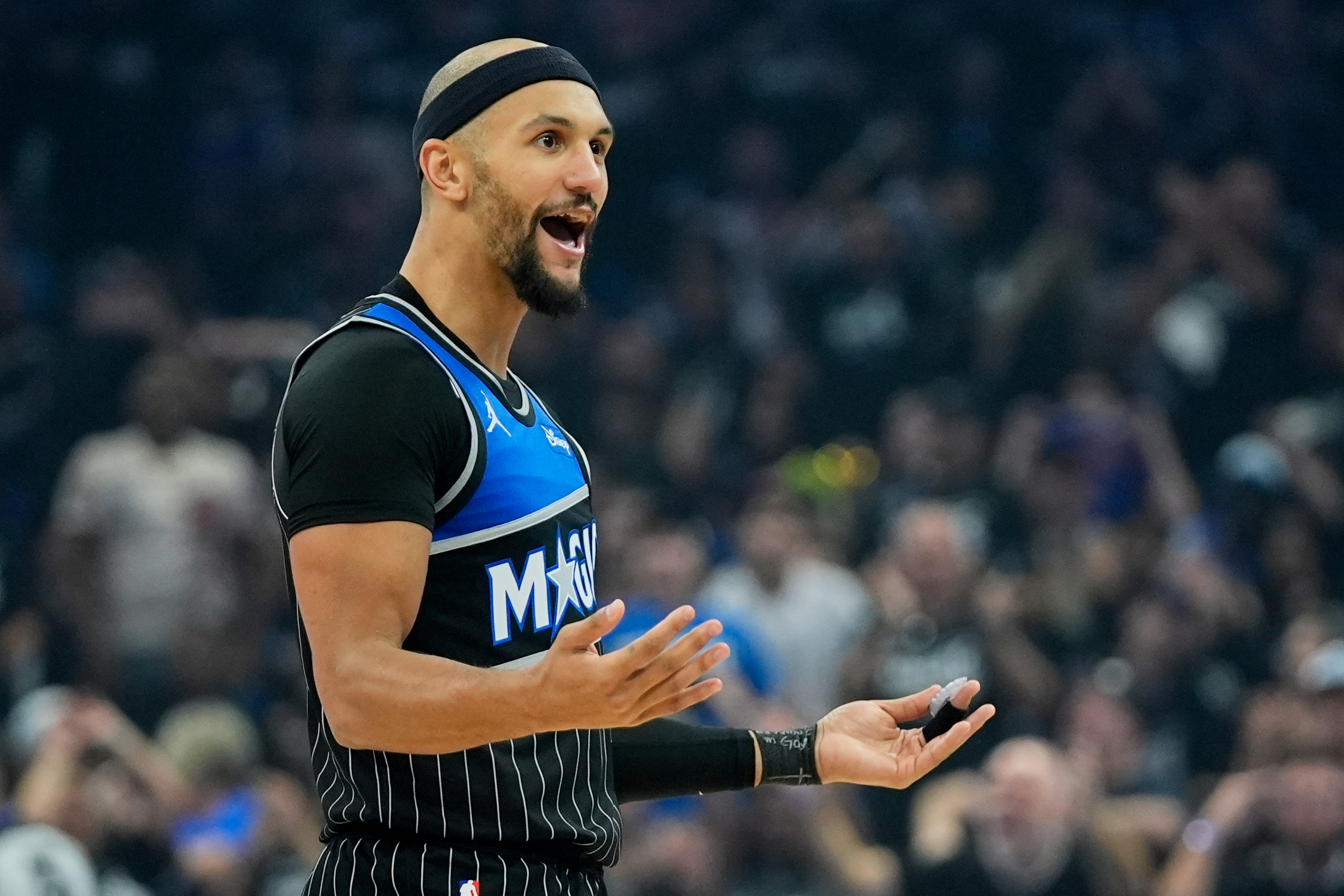 Orlando Magic guard Jalen Suggs interacts with fans after sinking a 3-point shot against the Detroit Pistons during the first half in Game 3 of a first-round NBA basketball playoff series basketball game, Saturday, April 25, 2026, in Orlando, Fla. 