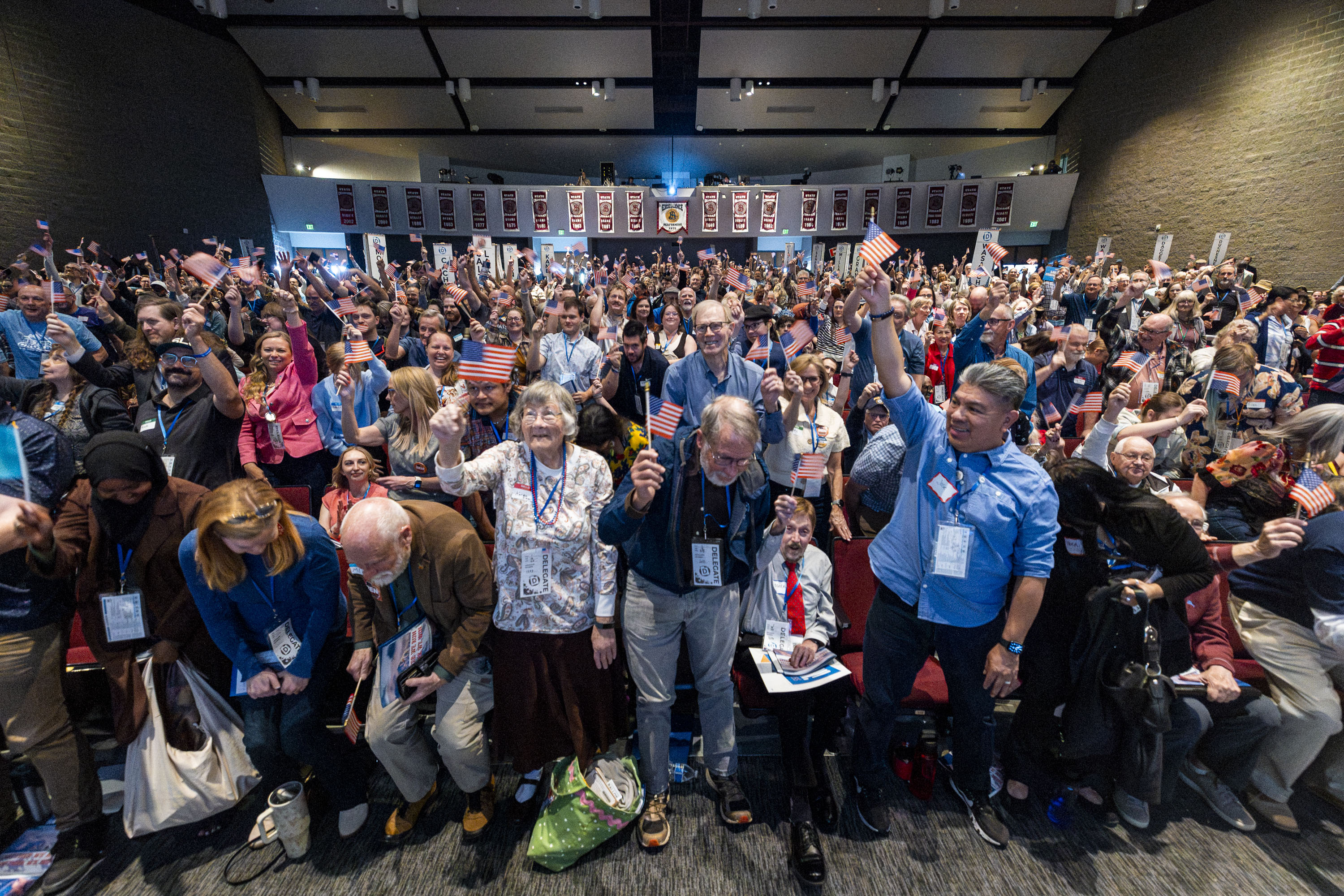 Attendees wave American flags as they create a wave throughout the crowd during the Utah Democratic Party State Convention held at Jordan High School in Sandy on Saturday.
