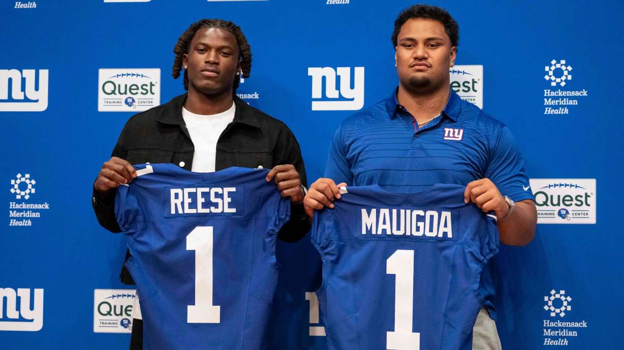 New York Giants' first round draft pick Arvell Reese, left, and Francis Mauigoa, right, pose for a picture during an NFL football press conference at the team's training facility, Friday, April 24, 2026, in East Rutherford, N.J.