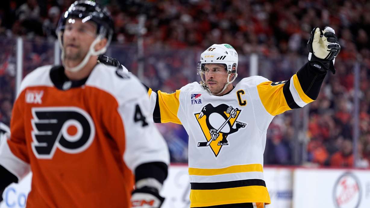Pittsburgh Penguins' Sidney Crosby, right, reacts behind Philadelphia Flyers' Luke Glendening after scoring during the first period of Game 4 in the first round of the NHL Stanley Cup hockey playoff series Saturday, April 25, 2026, in Philadelphia.