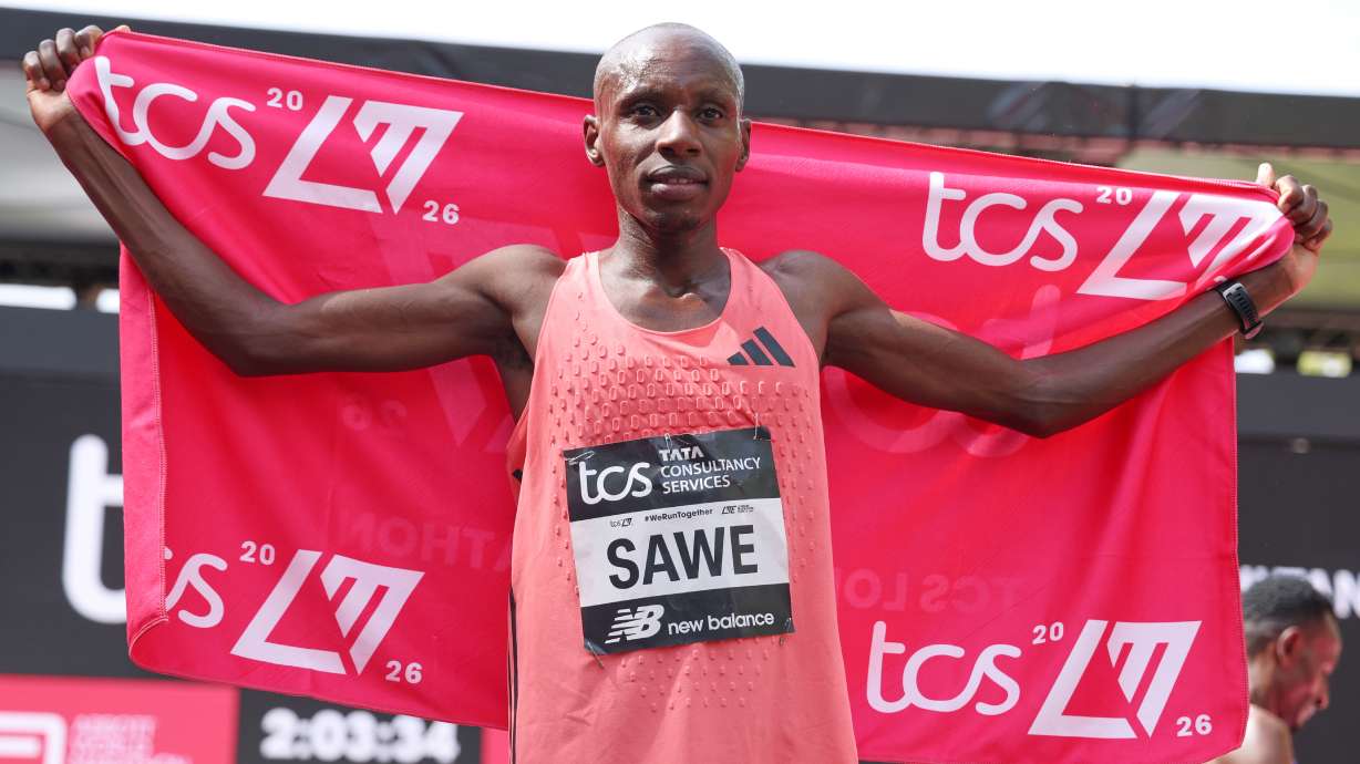 Sebastian Sawe from Kenya celebrates winning the men's race at the London Marathon in London, Sunday, April 26, 2026.