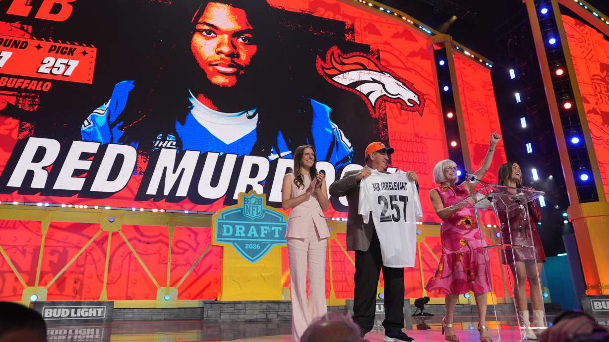Melanie Salata Fitch, second from right announces Red Murdock as the final pick, referred to as Mr. Irrelevant, by the Denver Broncos, during third day of the NFL football draft, Saturday, April 25, 2026, in Pittsburgh.