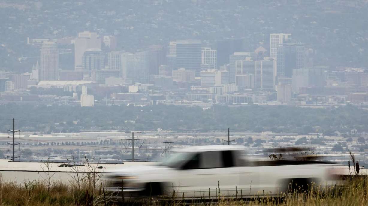 A motorist drives along 6200 South in West Valley City as the Salt Lake City skyline stands in the background on July 15, 2025. New study finds nearly half of America's children live in areas with air pollution levels that can pose a health risk.