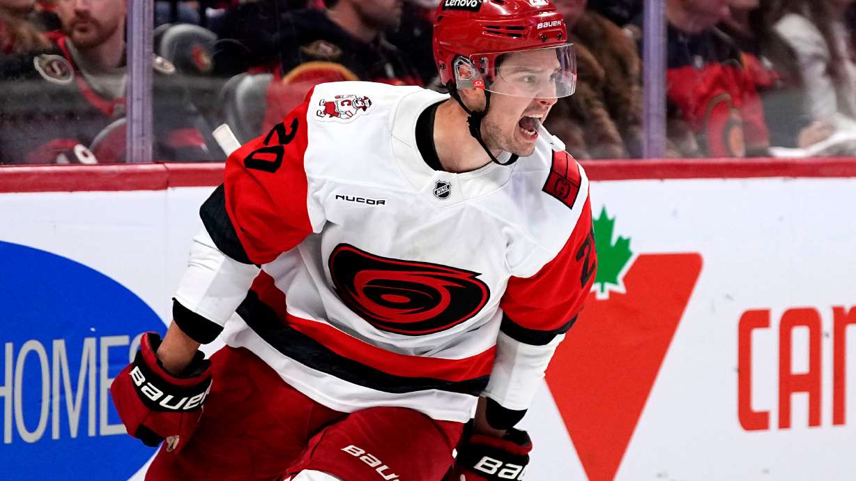 Carolina Hurricanes' Sebastian Aho (20) celebrates scoring an empty net goal against the Ottawa Senators in the third period in Game 4 of a first-round NHL Stanley Cup playoff hockey series, Saturday, April 25, 2026, in Ottawa, Ontario.