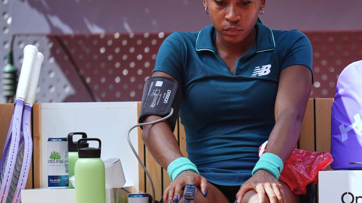 Coco Gauff of the United States receives medical attention during her match against Sorana Cirstea of Romania at the Madrid Open tennis tournament, Sunday, April 26, 2026, in Madrid.