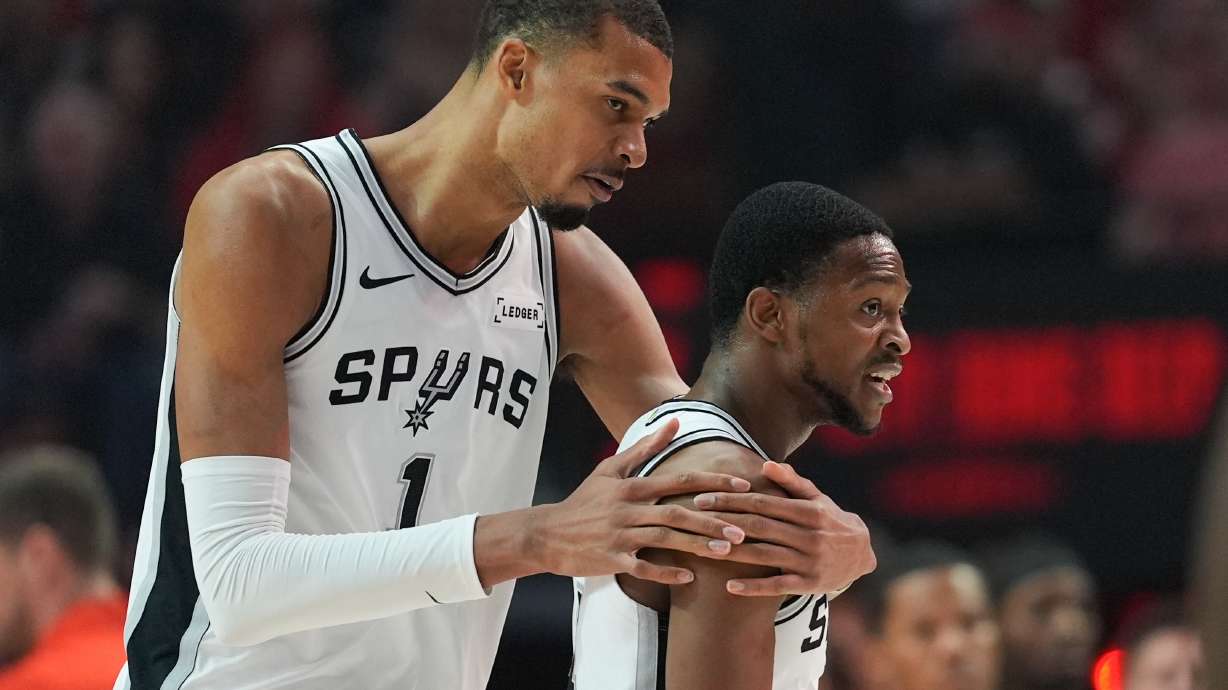 San Antonio Spurs forward/center Victor Wembanyama (1) reacts with guard De'aaron Fox after aplay during the first half in Game 4 of a first-round NBA basketball playoffs series against the Portland Trail Blazers, in Portland, Ore., Sunday, April 26, 2026.