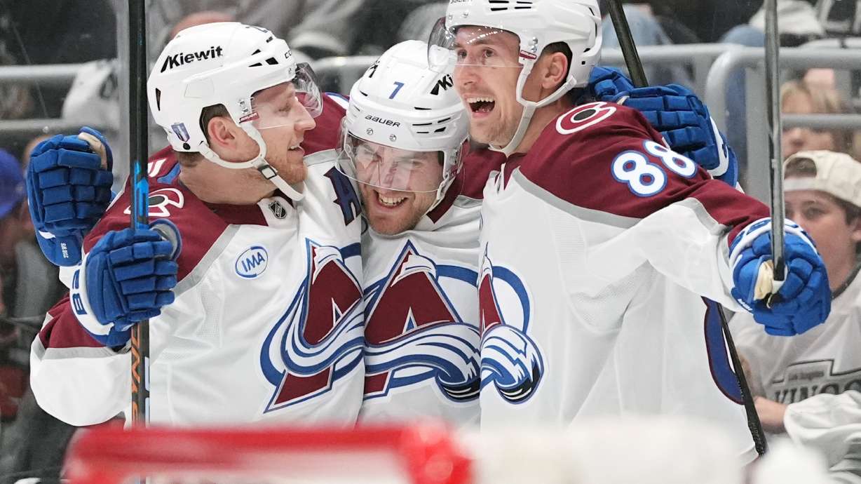 Colorado Avalanche's Devon Toews (7) celebrates his goal with Nathan MacKinnon (29) and Martin Necas (88) against the Los Angeles Kings during the third period of Game 4 in the first round of an NHL hockey Stanley Cup playoff series Sunday, April 26, 2026, in Los Angeles.