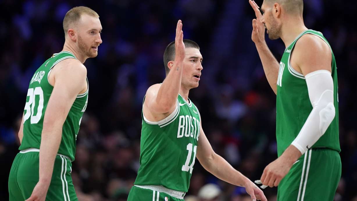 Boston Celtics' Sam Hauser, from left, Payton Pritchard and Nikola Vucevic react during the first half of Game 4 against the Philadelphia 76ers in a first-round NBA basketball playoffs series Sunday, April 26, 2026, in Philadelphia.