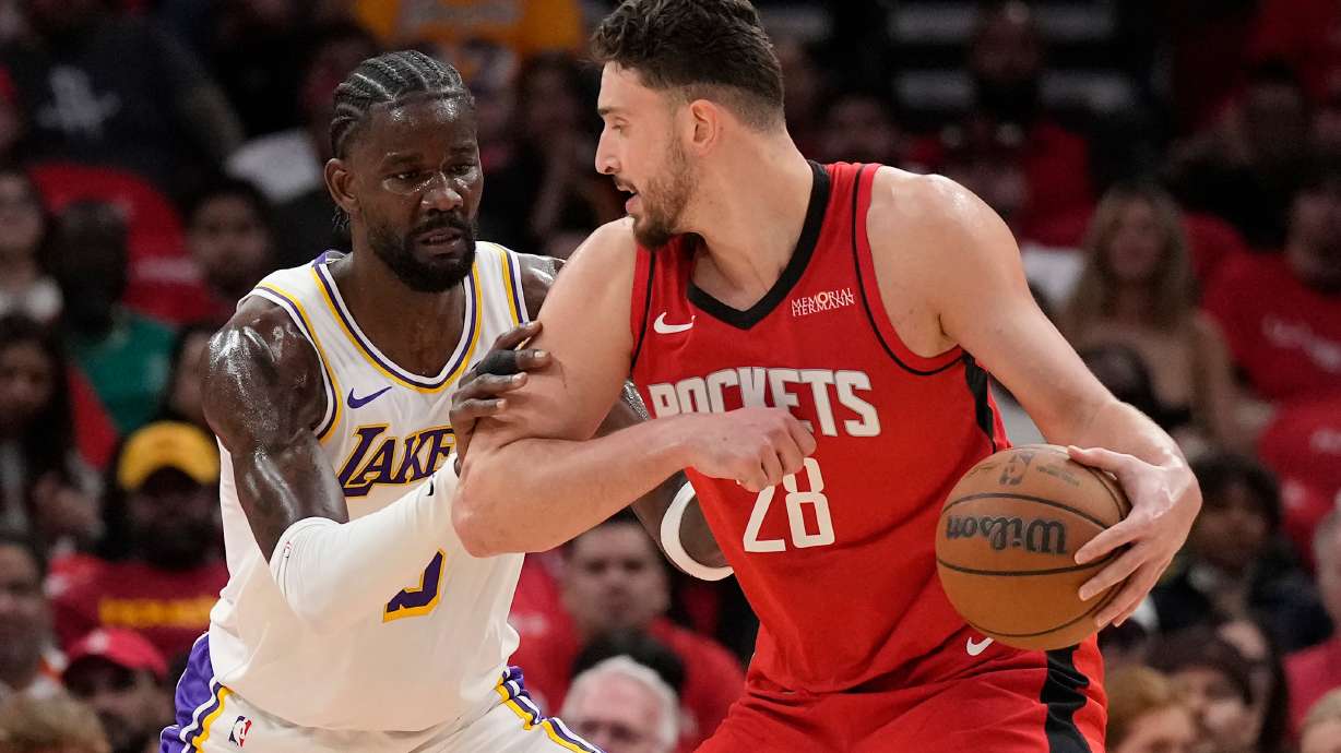 Houston Rockets center Alperen Sengun (28) controls the ball against Los Angeles Lakers center Deandre Ayton (5) during the first half in Game 4 of a first-round NBA basketball playoffs series, Sunday, April 26, 2026, in Houston.