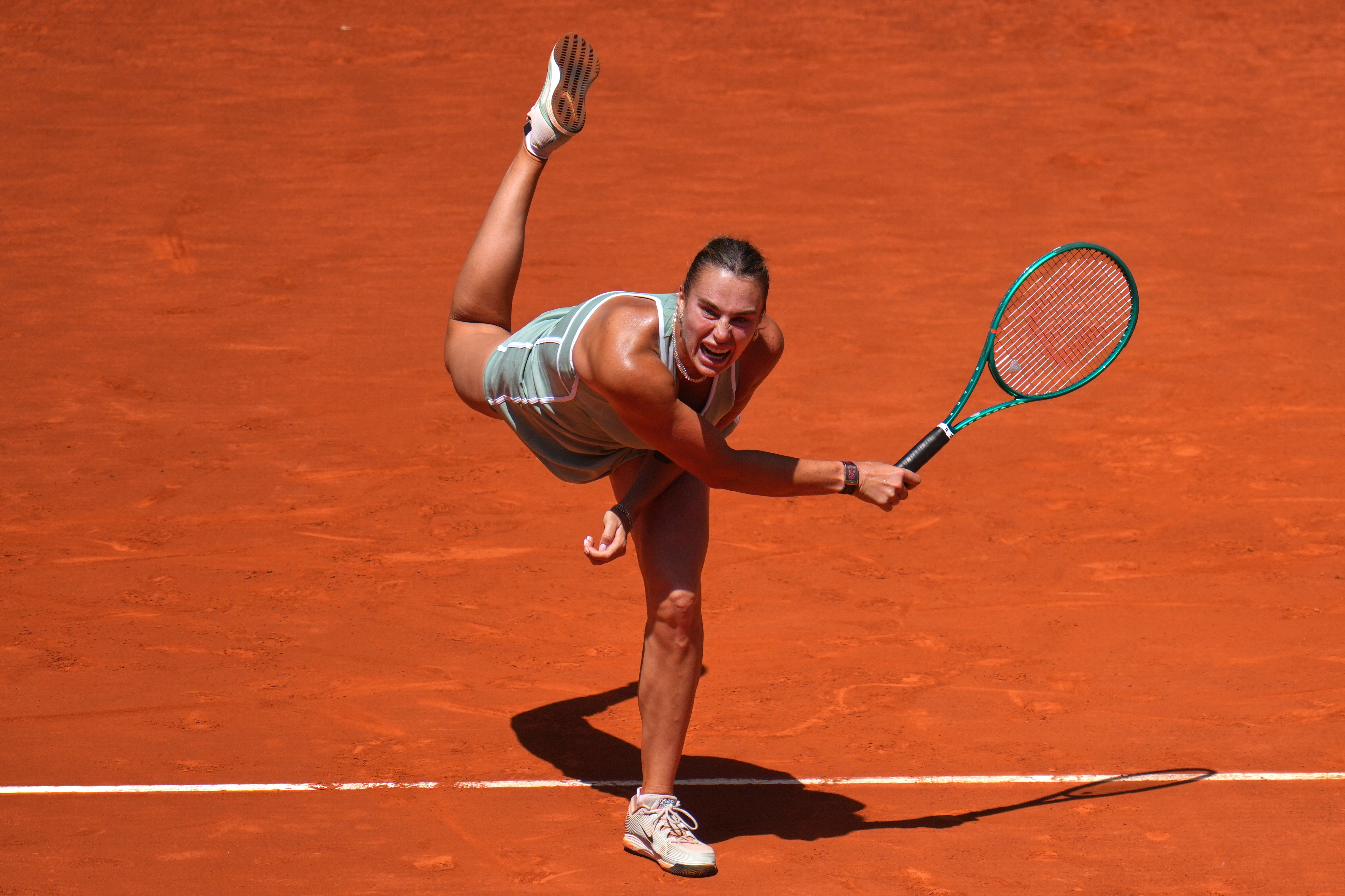 Aryna Sabalenka of Belarus serves the ball to Naomi Osaka of Japan during the Madrid Open tennis tournament in Madrid, Monday, April 27, 2026. 