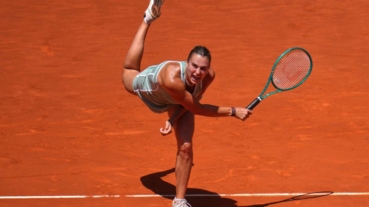 Aryna Sabalenka of Belarus serves the ball to Naomi Osaka of Japan during the Madrid Open tennis tournament in Madrid, Monday, April 27, 2026.