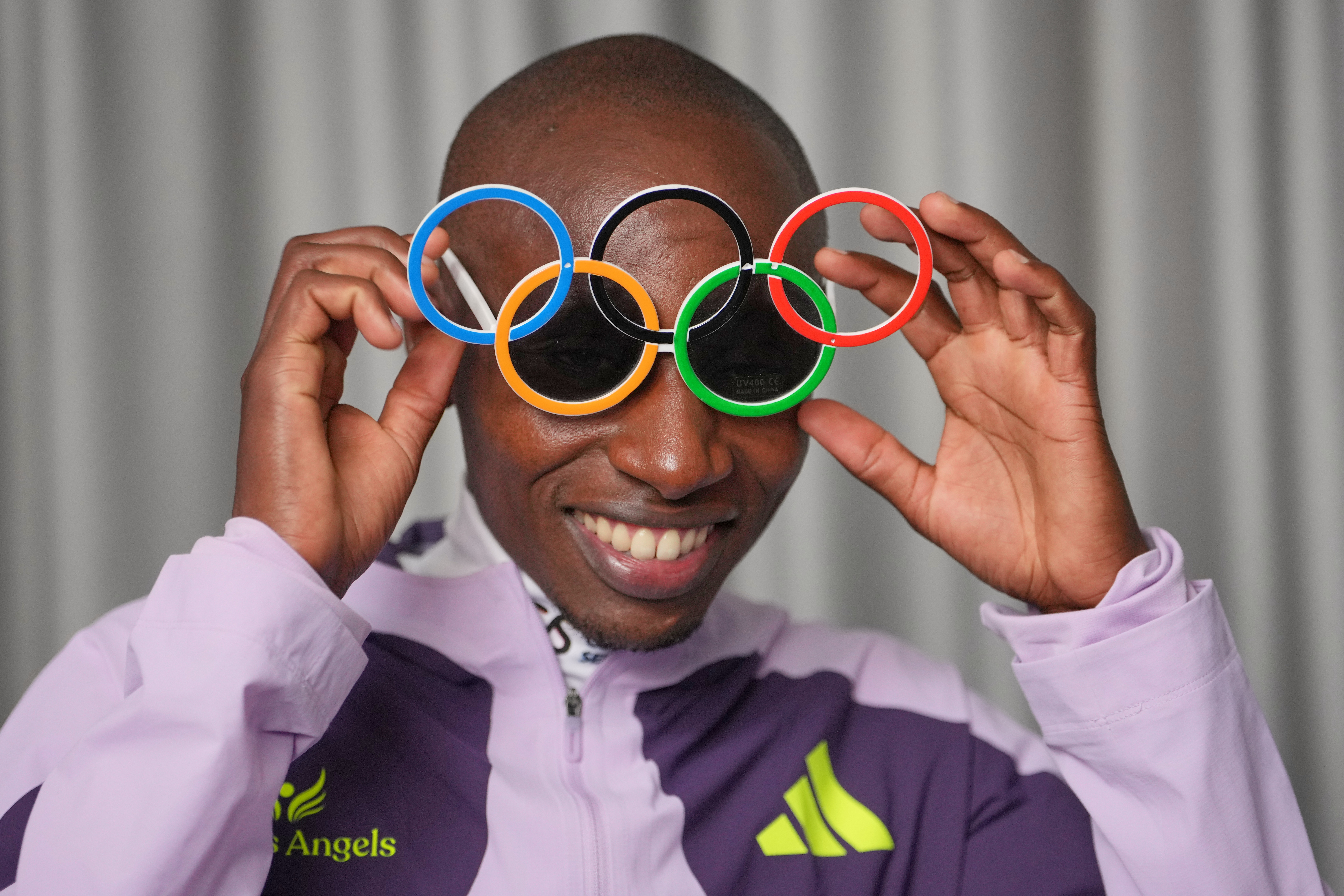 Kenya's Sabastian Sawe poses with Olympic Ring sun-glasses during an interview with The Associated Press after winning the London Marathon, in London, Monday, April 27, 2026. 