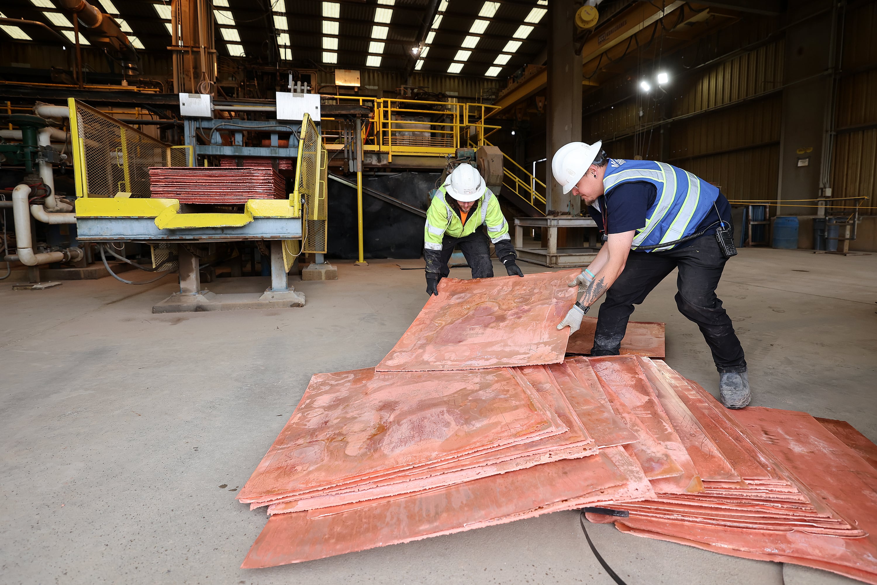 Brenton Hymas, Mariana Minerals process ship supervisor, right, and another Mariana Minerals employee move sheets of copper at Mariana Minerals’ Copper One mine in San Juan County on Monday. The mine will use autonomous tools for mining, refining and capital project execution.