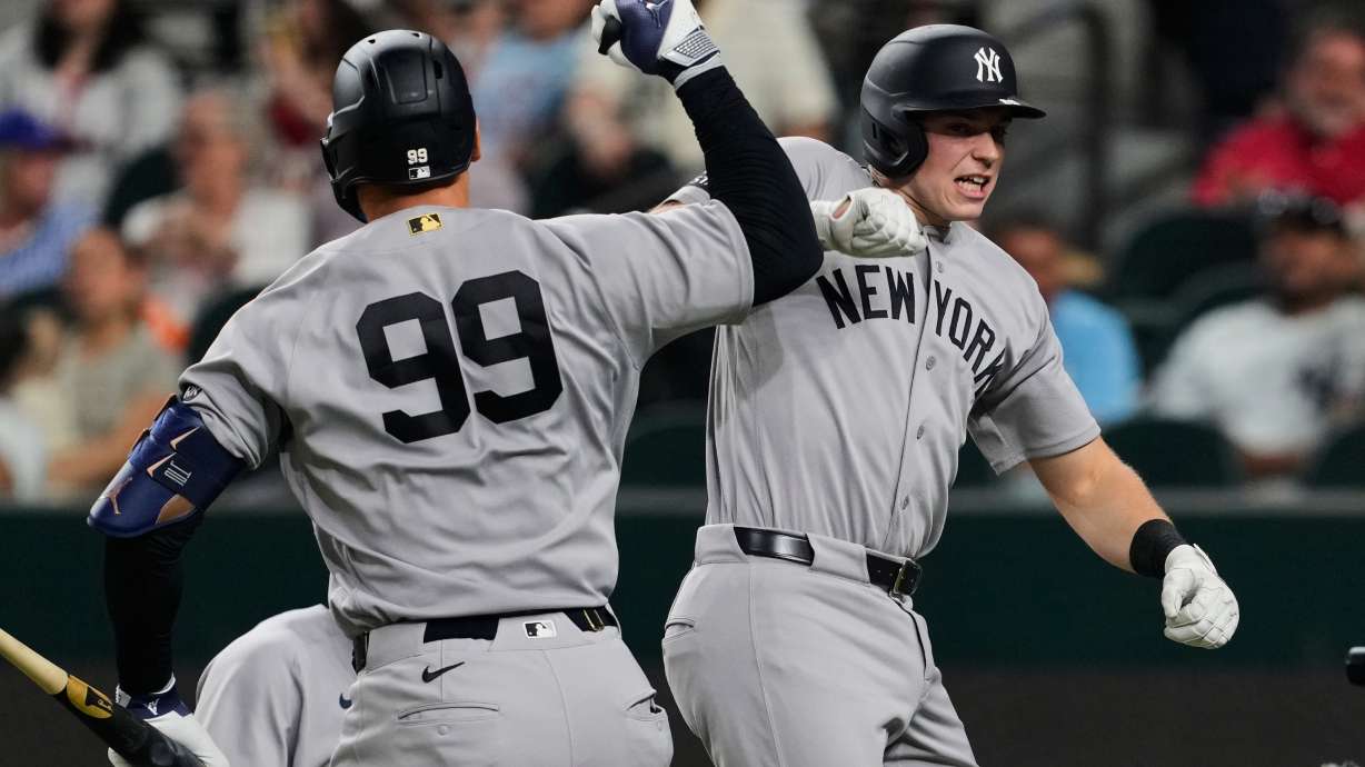 New York Yankees' Aaron Judge and Ben Rice, right, celebrate Rice's two-run home run in the third inning of a baseball game against the Texas Rangers Monday, April 27, 2026, in Arlington, Texas.