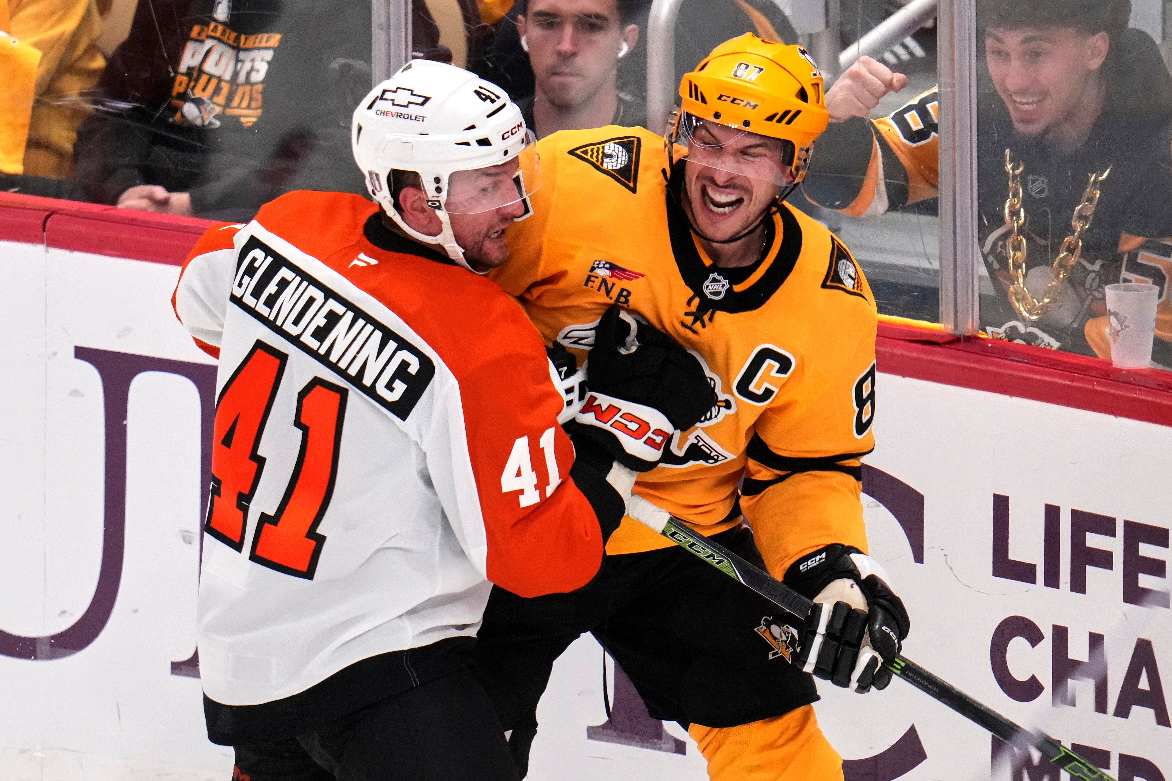 Pittsburgh Penguins' Sidney Crosby, right, is defended by Philadelphia Flyers' Luke Glendening (41) during the third period of Game 5 in the first round of an NHL hockey Stanley Cup playoff series in Pittsburgh, Monday, April 27, 2026. 