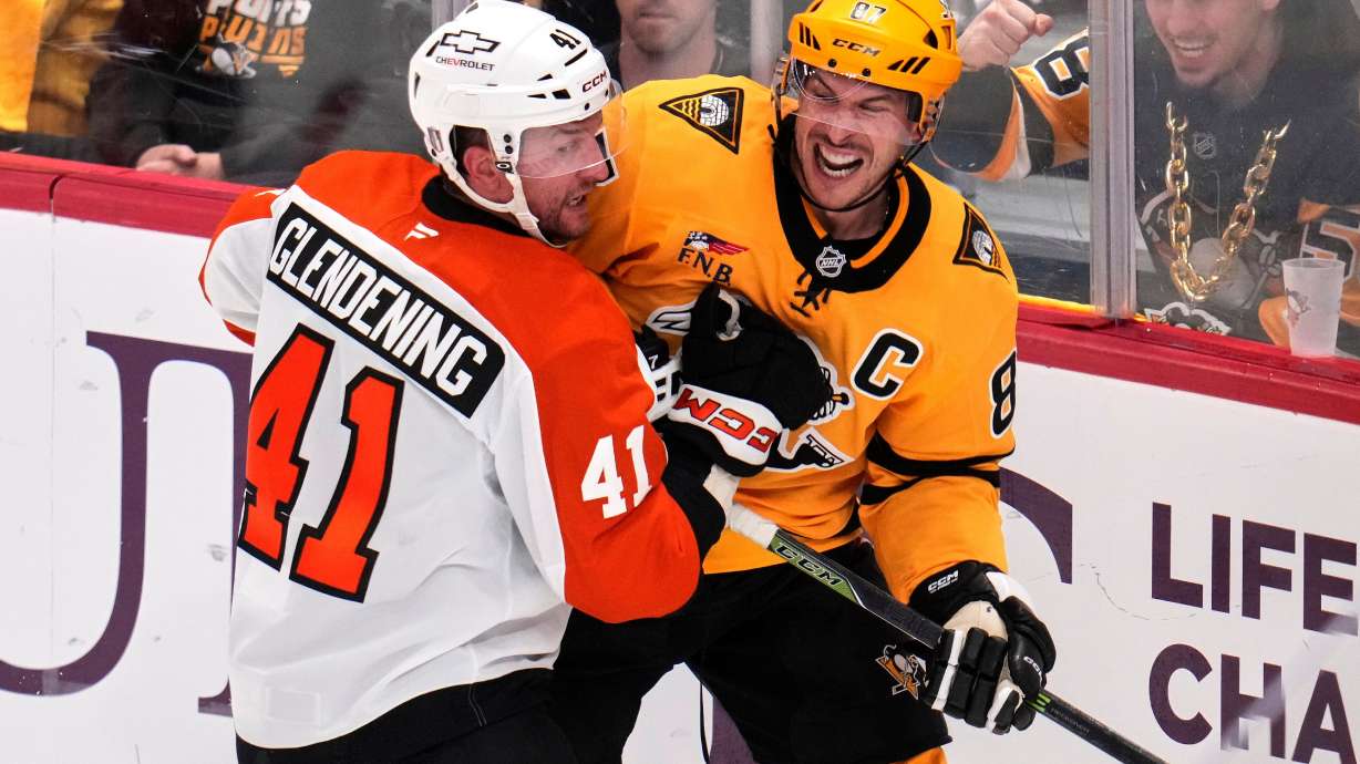 Pittsburgh Penguins' Sidney Crosby, right, is defended by Philadelphia Flyers' Luke Glendening (41) during the third period of Game 5 in the first round of an NHL hockey Stanley Cup playoff series in Pittsburgh, Monday, April 27, 2026.