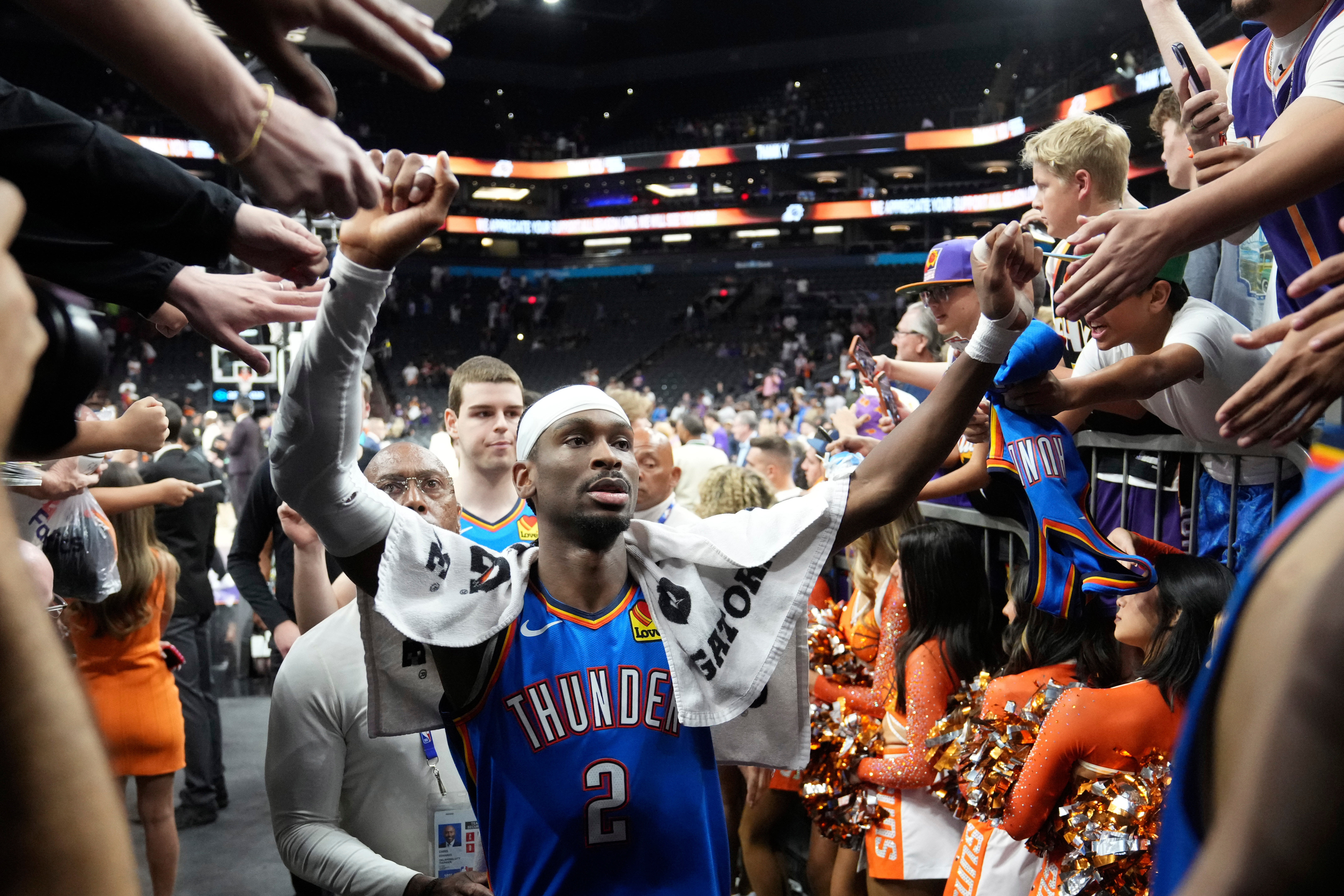 Oklahoma City Thunder guard Shai Gilgeous-Alexander celebrates with fans after Game 4 in a first-round NBA playoffs basketball series against the Phoenix Suns, Monday, April 27, 2026, in Phoenix. 