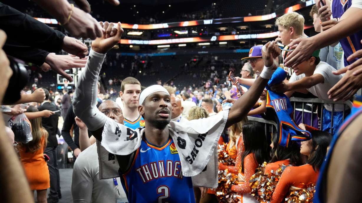 Oklahoma City Thunder guard Shai Gilgeous-Alexander celebrates with fans after Game 4 in a first-round NBA playoffs basketball series against the Phoenix Suns, Monday, April 27, 2026, in Phoenix.