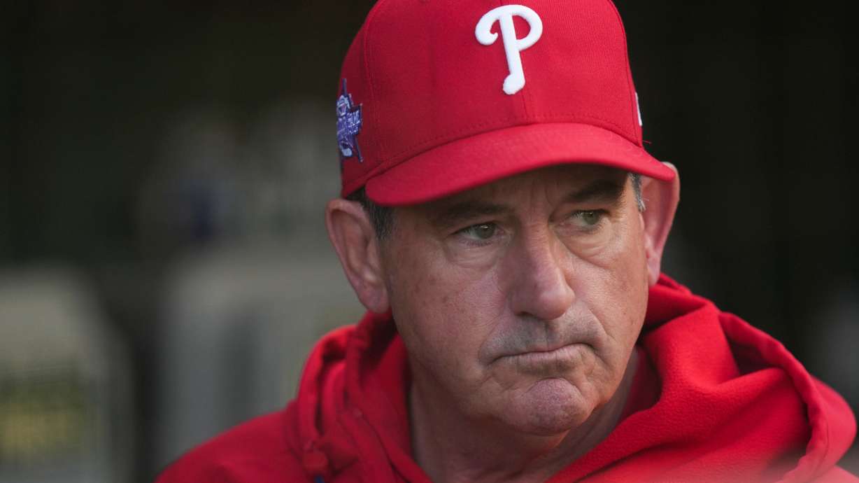 Philadelphia Phillies manager Rob Thomson (49) stands in the dugout before a baseball game against the Chicago Cubs, Wednesday, April 22, 2026, in Chicago.
