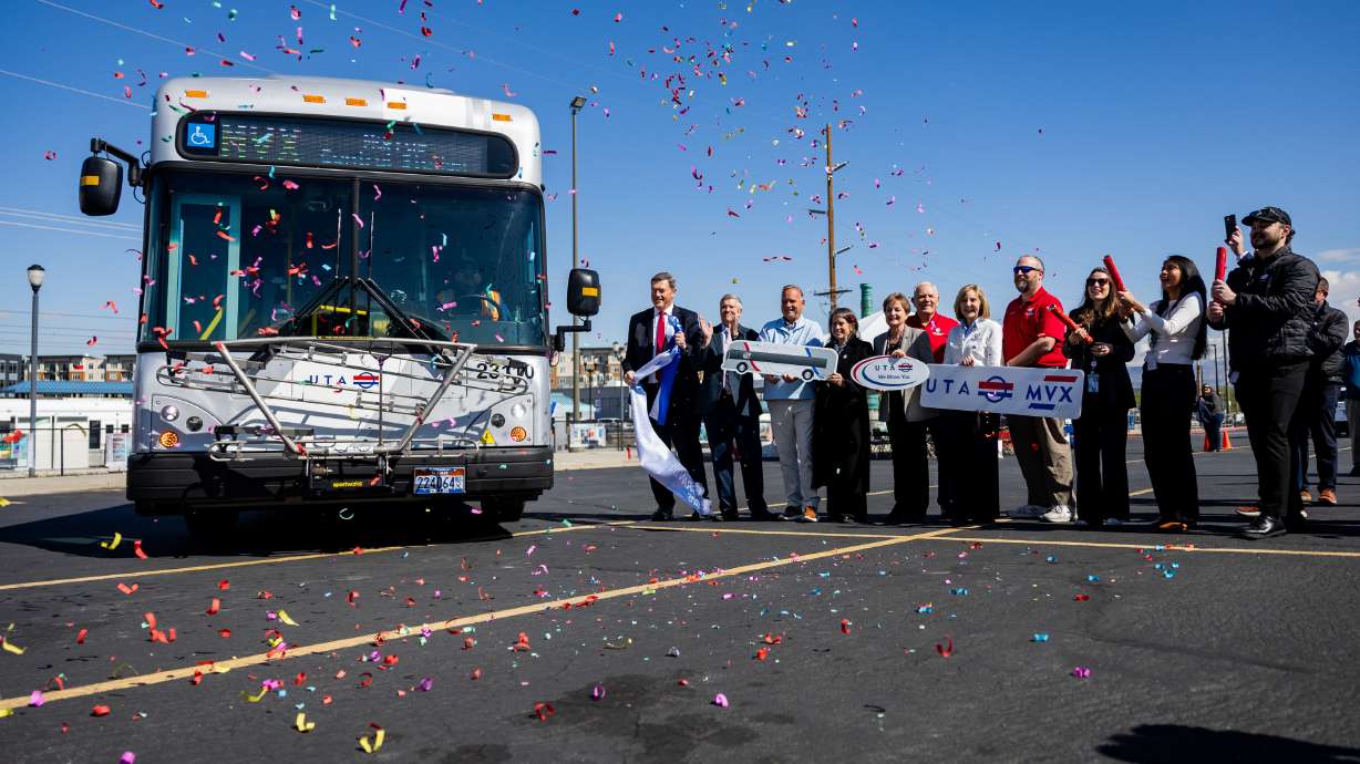 UTA representatives stand as confetti fills the sky after a Midvalley Express bus drove forward to cut the ribbon during a grand opening event for the new Midvalley Express, a 7-mile all-electric bus rapid transit route, in Murray on Tuesday.