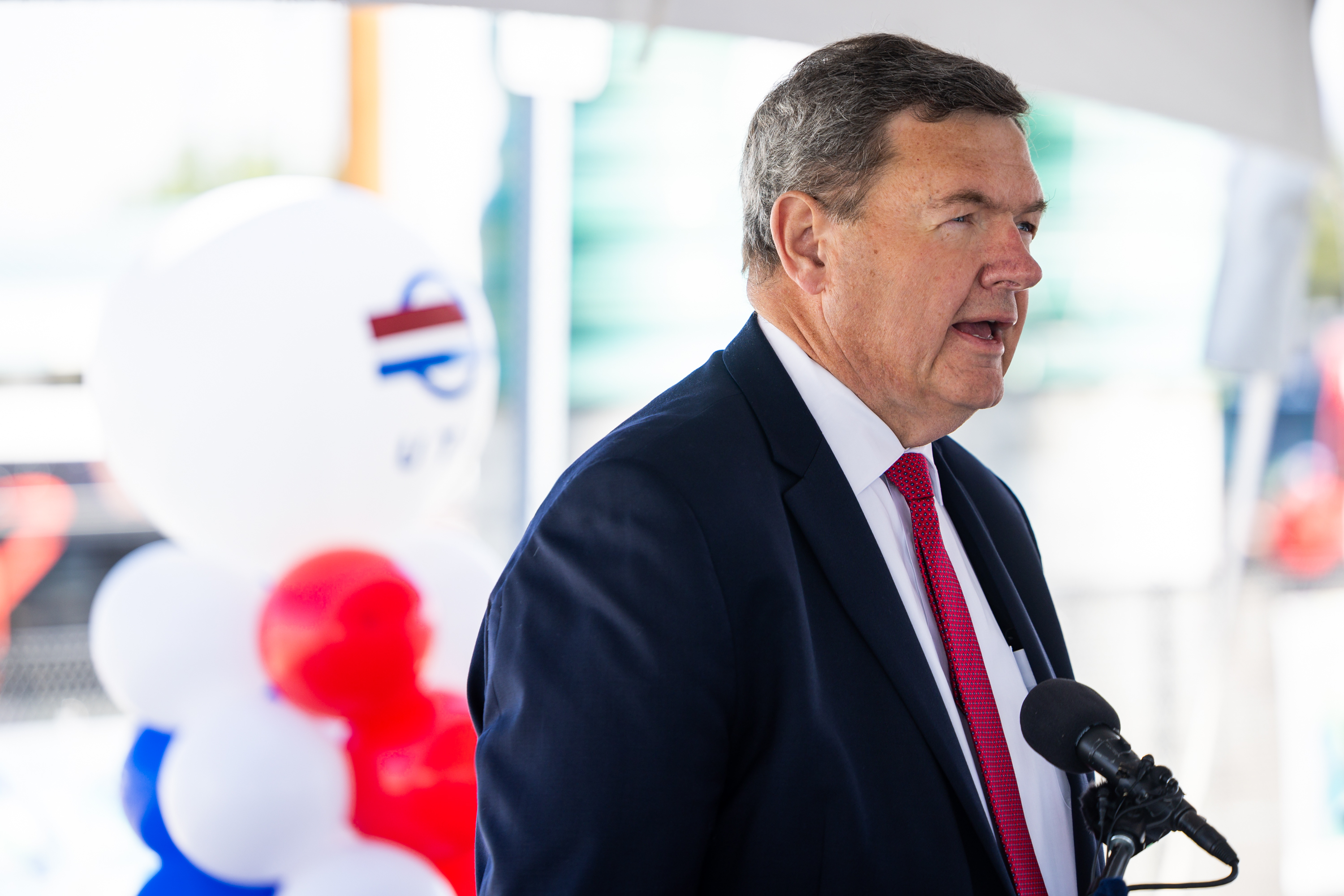 Carlton Christensen, UTA board chair, speaks during a grand opening and ribbon-cutting event for the new Midvalley Express, a 7-mile all-electric bus rapid transit route that runs between West Valley Central and Murray Central stations, at Murray Central Station in Murray on Tuesday.