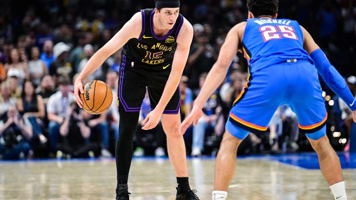 Los Angeles Lakers guard Austin Reaves (15) drives against Oklahoma City Thunder guard Ajay Mitchell (25) during the first half of an NBA basketball game Thursday, April. 2, 2026, in Oklahoma City.