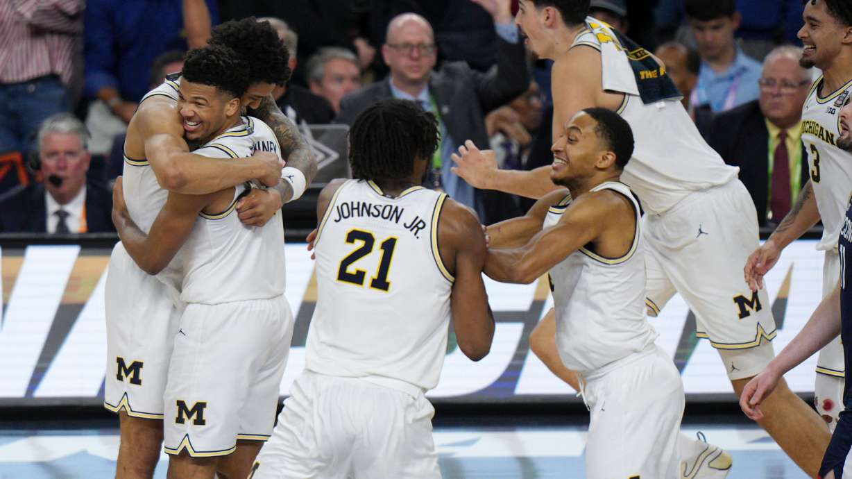 Michigan celebrates after defeating UConn in the NCAA college basketball tournament national championship game at the Final Four, Monday, April 6, 2026, in Indianapolis.