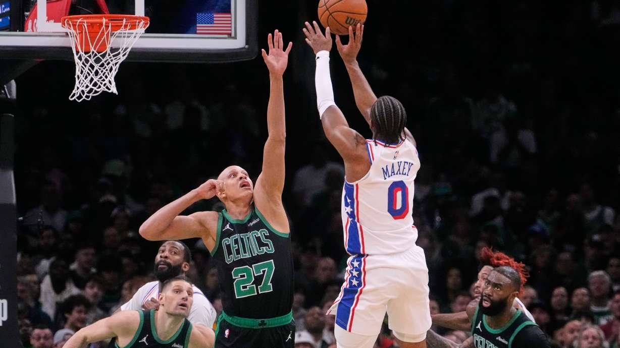 Philadelphia 76ers guard Tyrese Maxey (0) takes a shot over Boston Celtics guard Jordan Walsh (27) during the first half of Game 5 of a first-round NBA playoffs basketball series, Tuesday, April 28, 2026, in Boston.