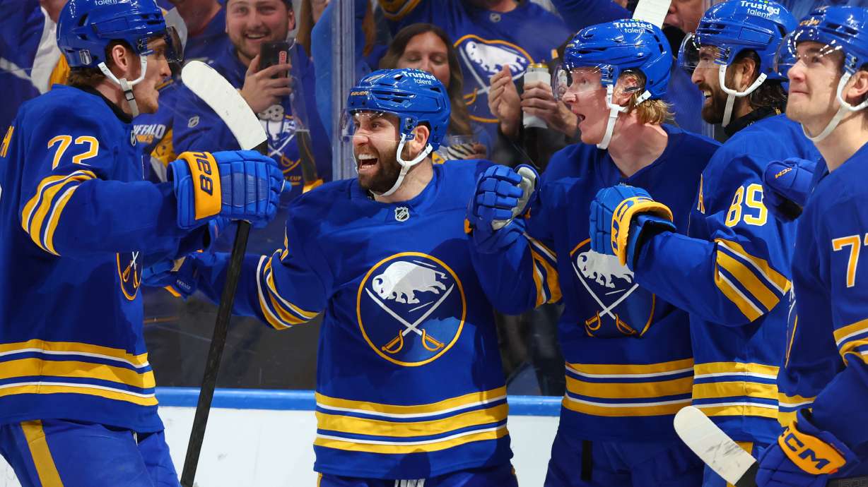 Buffalo Sabres teammates celebrate a goal by defenseman Rasmus Dahlin (26) during the first period in Game 5 of a first-round NHL hockey Stanley Cup playoff series against the Boston Bruins Tuesday, April 28, 2026, in Buffalo, N.Y.