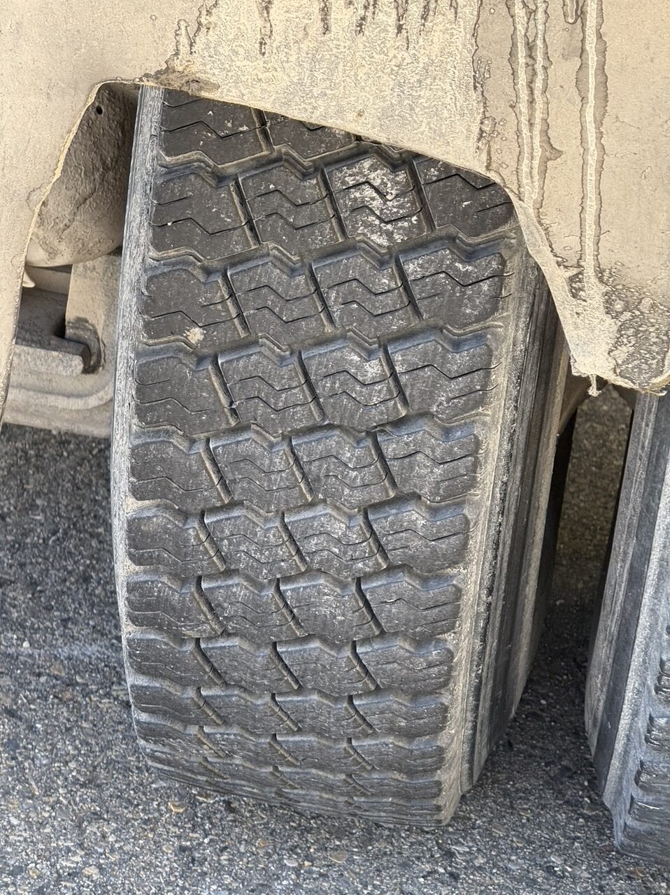 The worn mud flaps of the dump truck that alleged kicked up a rock that damaged Philip Munoa's windshield. Munoa said the truck company refused to pay for damaging his windshield.