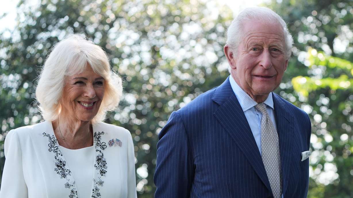 Britain's King Charles III and Queen Camilla stand next to the White House bee hive on the South Lawn of the White House, Monday, in Washington.