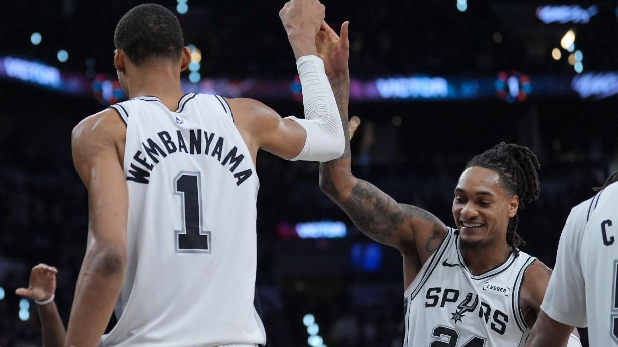 San Antonio Spurs forward/center Victor Wembanyama (1) reacts with guard/forward Devin Vassell (24) during the second half in Game 5 of a first-round NBA playoffs basketball series against the Portland Trail Blazers, in San Antonio, Tuesday, April 28, 2026.