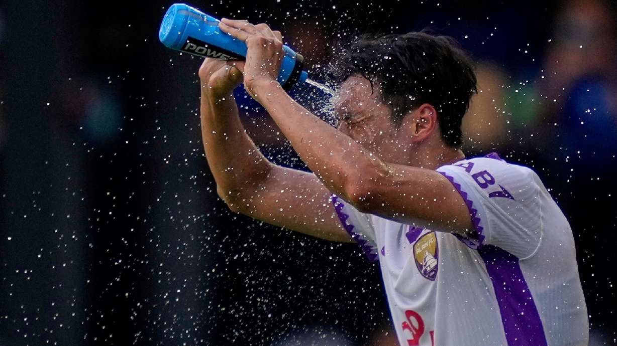FILE - Al Ain's Park Yong-woo cools off during the Club World Cup Group G soccer match between Wydad AC and Al Ain FC in Washington, June 26, 2025.
