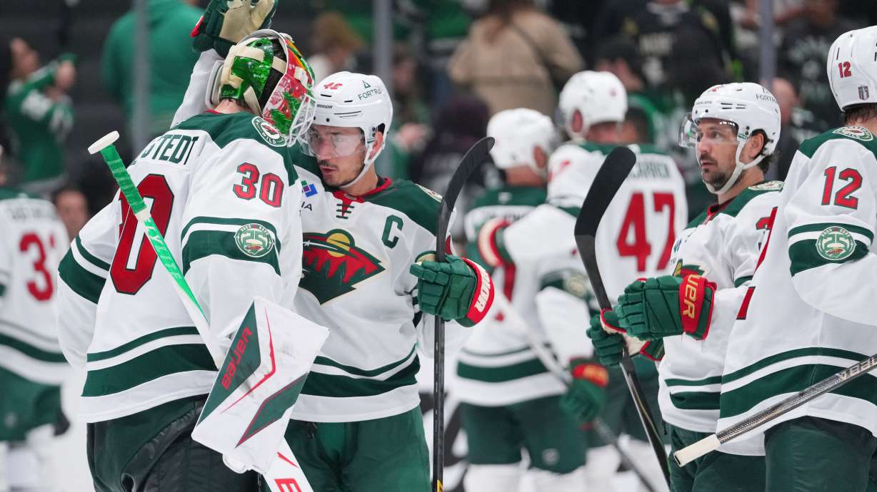 Minnesota Wild goaltender Jesper Wallstedt (30) reacts with defenseman Jared Spurgeon (46) after their team defeated the Dallas Stars 4-2 in Game 5 of a first-round NHL Stanley Cup playoffs hockey series, Tuesday, April 28, 2026, in Dallas.