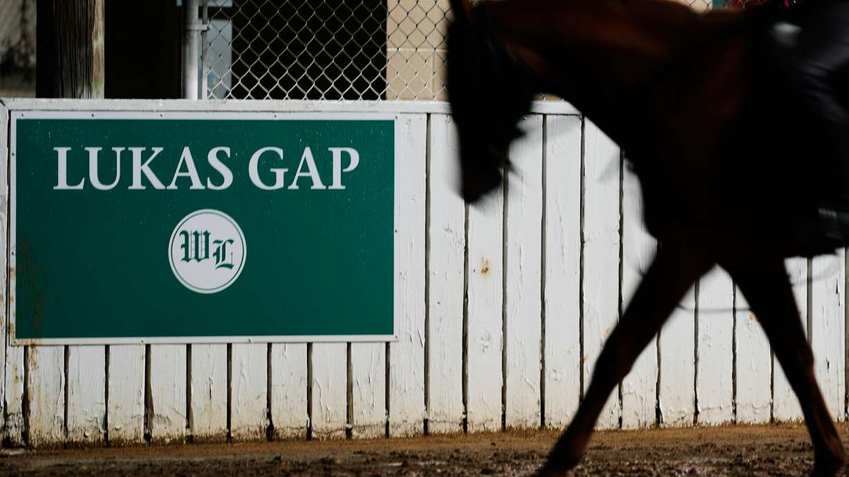 A horse comes off the track through the Lukas Gap gate, named in honor of deceased Hall of Fame trainer D. Wayne Lukas, Wednesday, April 29, 2026, at Churchill Downs in Louisville, Ky.
