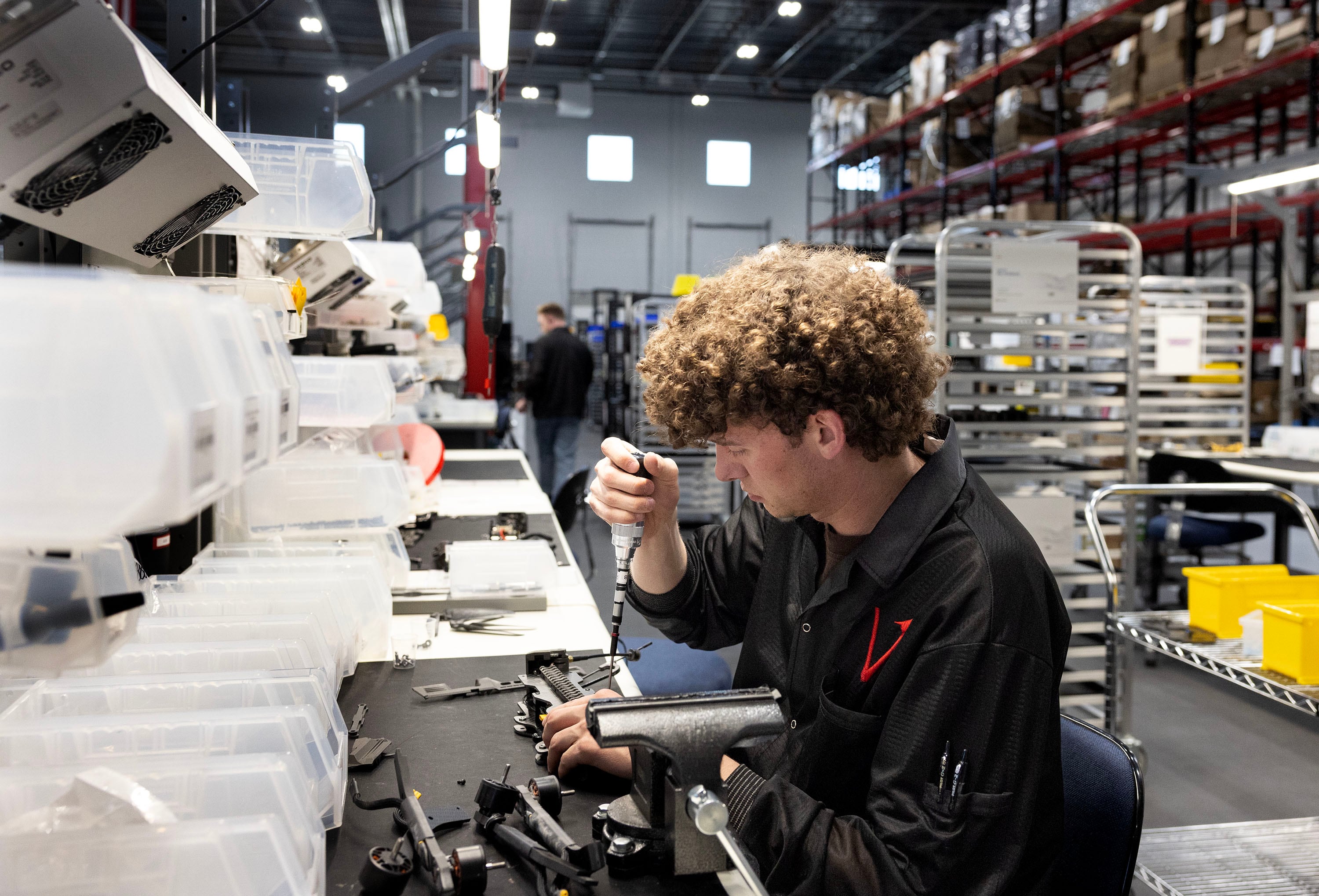 Trenton Landoni assembles Picatinny rails to carbon fiber plates at Vector in Bluffdale on Friday.