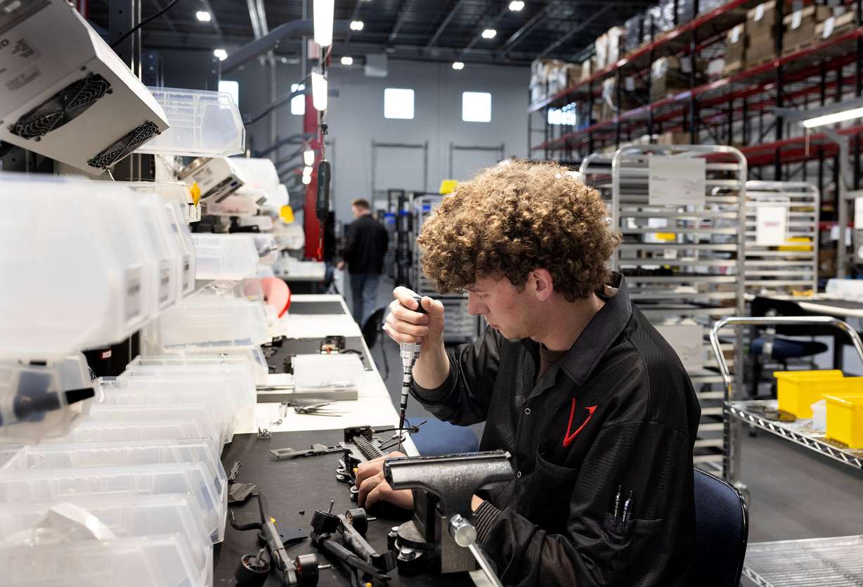 Trenton Landoni assembles Picatinny rails to carbon fiber plates at Vector in Bluffdale on Friday.