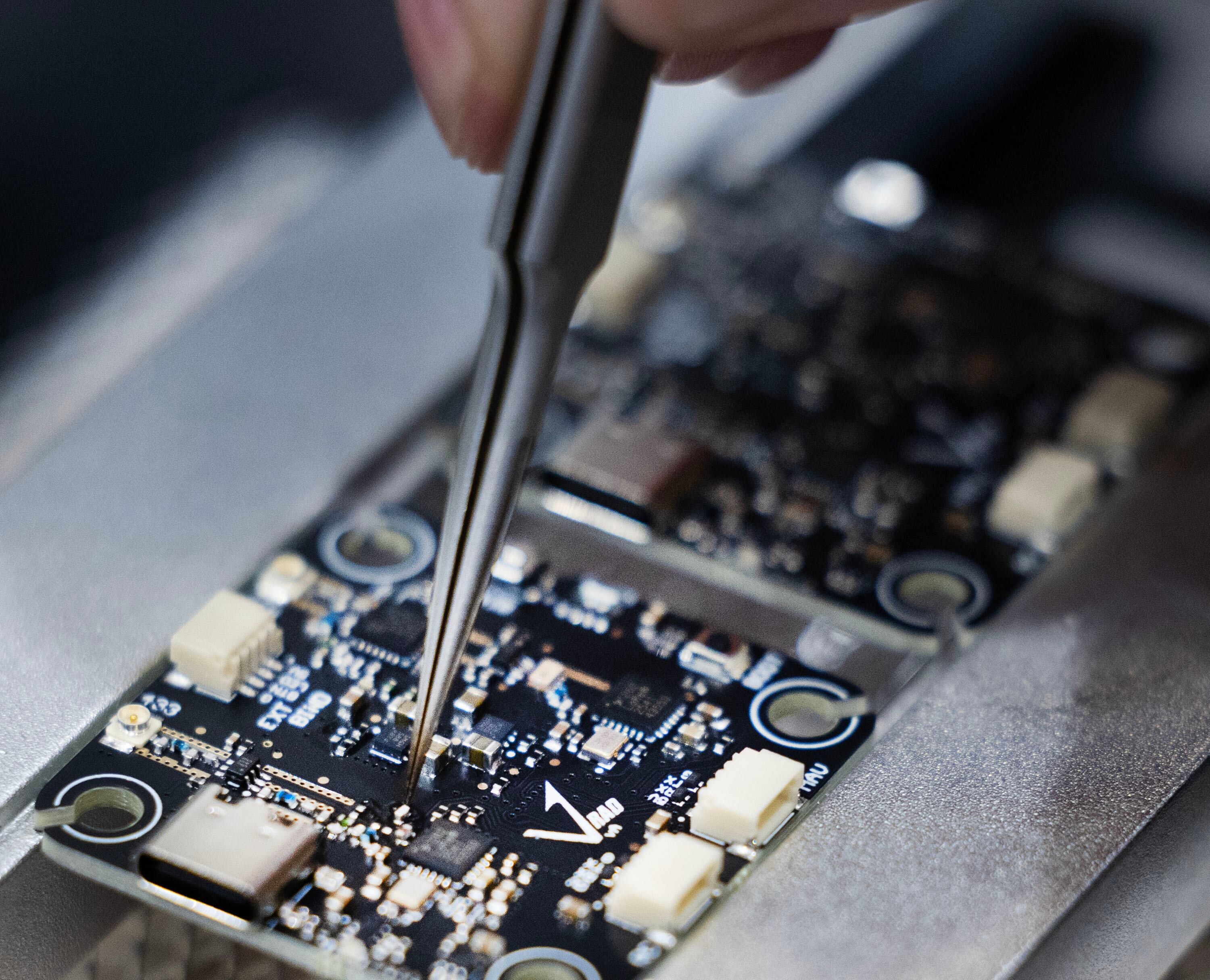 Internal components of a proprietary Vector radio are soldered at Vector in Bluffdale on Friday.