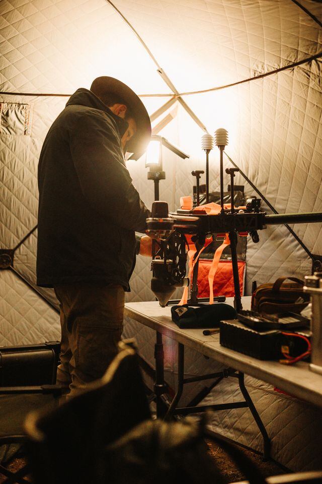 A forward operating specialist performing drone maintenance during a cloud seeding mission outside Pocatello, Idaho. Before Rainmaker, Utahns would use generators in hopes that silver iodide particles would reach the sky.