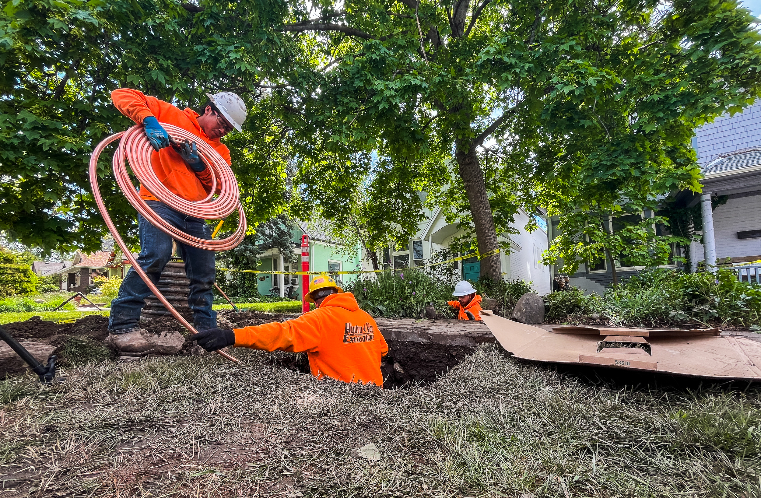 Excavation crews prepare to install a copper service line underneath the front yard of Spencer Hogan's Salt Lake City home on Wednesday. It's the first line replacement from Salt Lake City Department of Public Utilities' Lead and Copper Program.