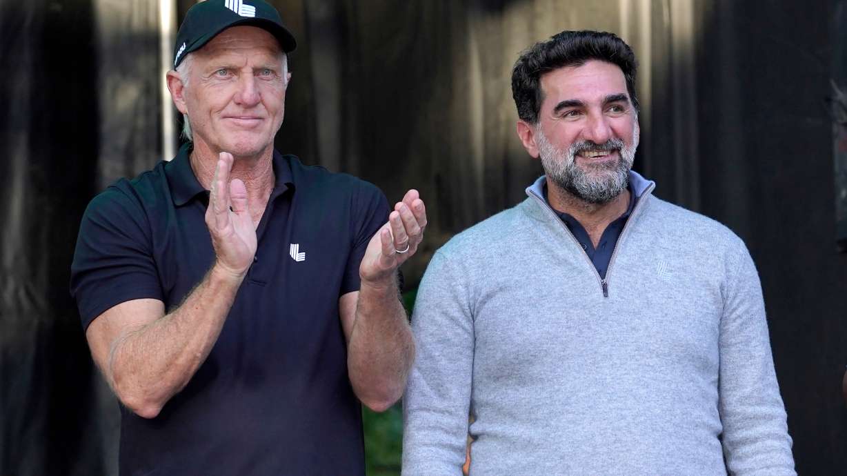FILE - LIV Golf CEO Greg Norman, left, applauds Yasir Al-Rumayyan, Governor of Public Investment Fund of Saudi Arabia, at the LIV Golf Invitational-Chicago tournament Sept. 18, 2022, in Sugar Hill, Ill.