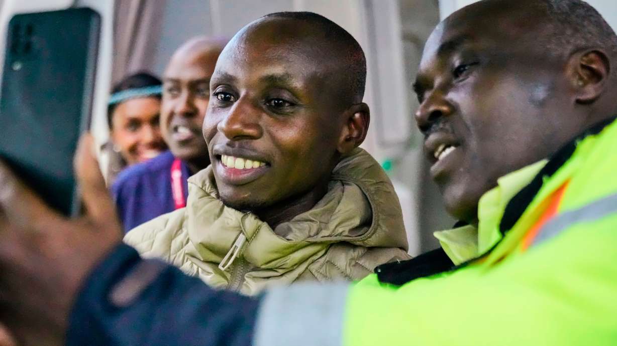 Sabastian Sawe poses for a selfie with an airport worker after arriving on a plane from London, Wednesday, April 29, 2026, at Jomo Kenyatta International Airport in Nairobi, Kenya, after setting a new world record in the marathon. CORRECTION: Corrects spelling of first name to Sabastian, not Sebastian