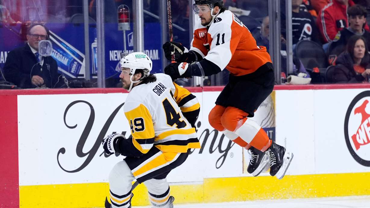 Philadelphia Flyers' Travis Konecny, right, leaps past Pittsburgh Penguins' Samuel Girard during the second period of Game 6 in the first round of the NHL hockey Stanley Cup playoffs series Wednesday, April 29, 2026, in Philadelphia.