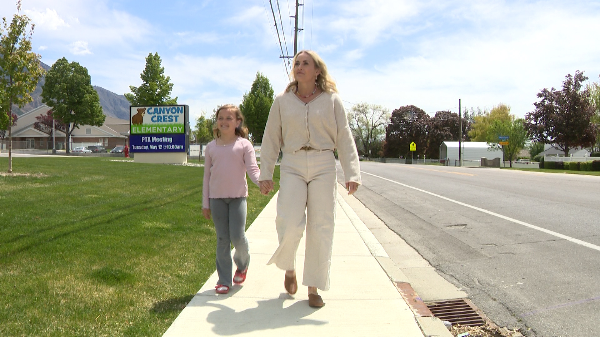 Brenna Borup walks with her daughter near Canyon Crest Elementary School in Provo on Wednesday. Borup is concerned the school district may attempt to sell the property.