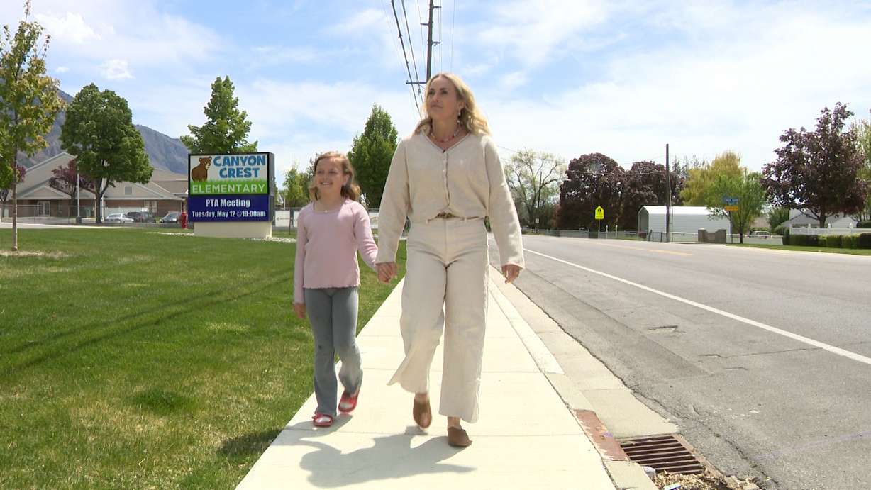 Brenna Borup walks with her daughter near Canyon Crest Elementary School in Provo on Wednesday. Borup is concerned the school district may attempt to sell the property.
