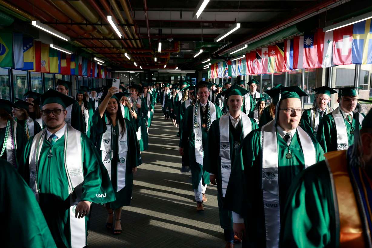 Utah Valley University graduates march into the UCCU Center in Orem for the spring graduation Wednesday.