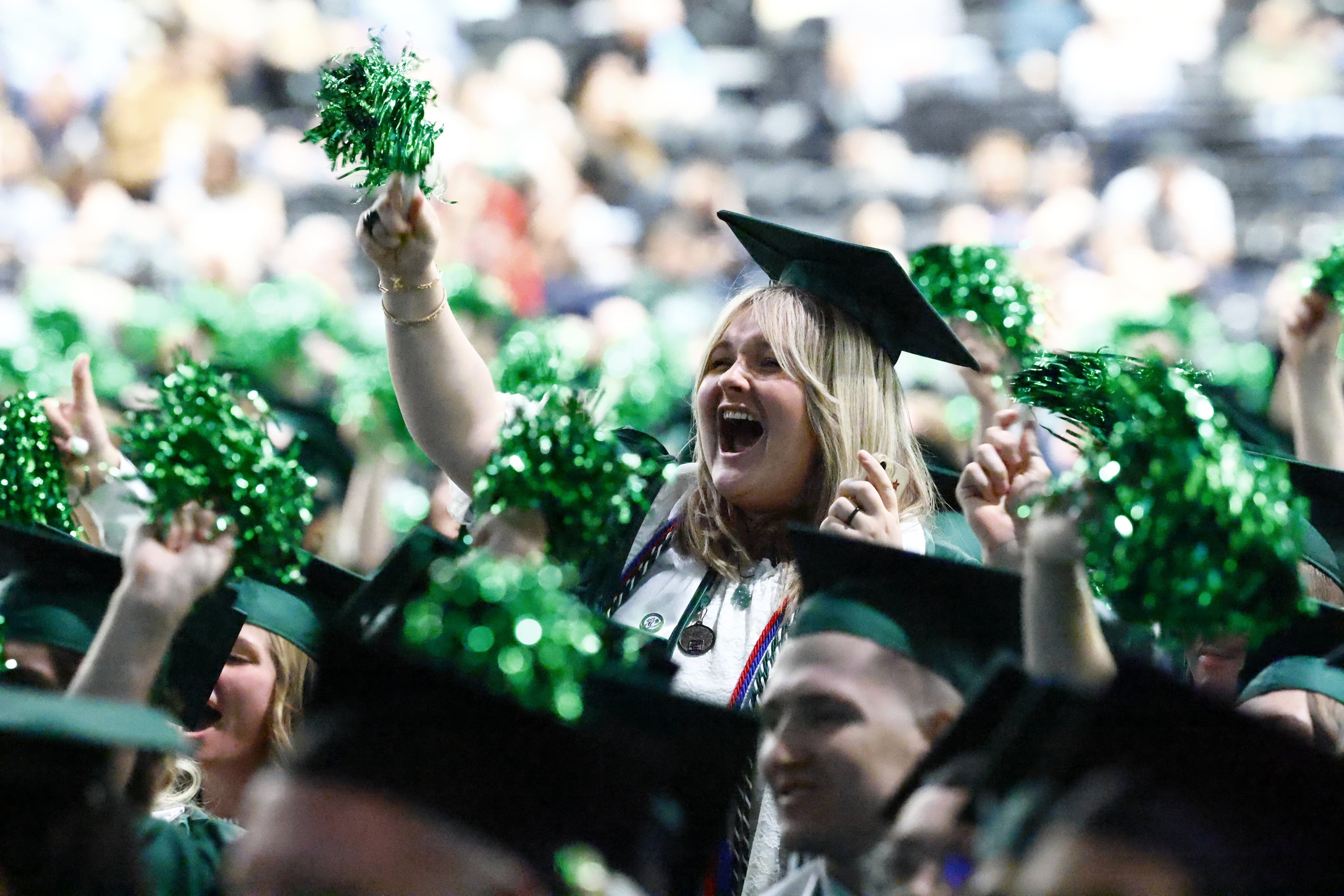 Utah Valley University graduates cheer inside the UCCU Center in Orem during the spring graduation Wednesday.