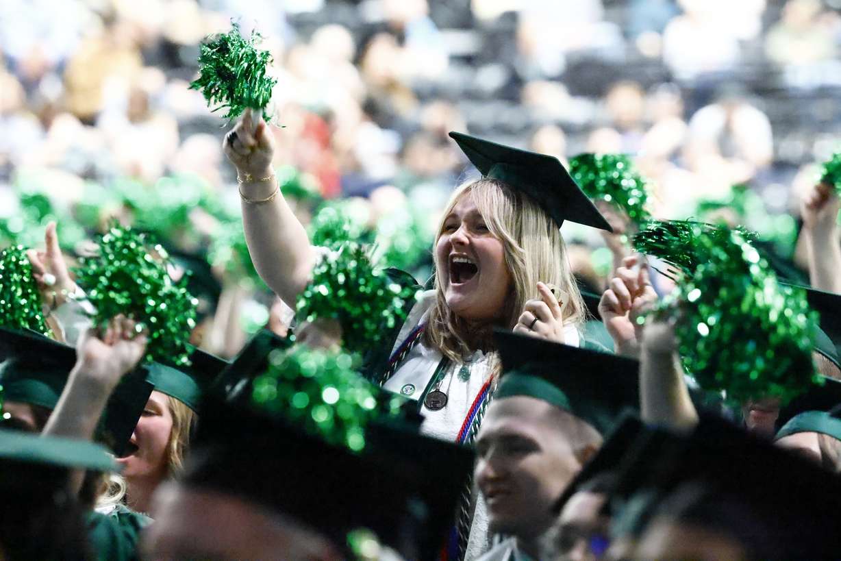 Utah Valley University graduates cheer inside the UCCU Center in Orem during the spring graduation Wednesday.