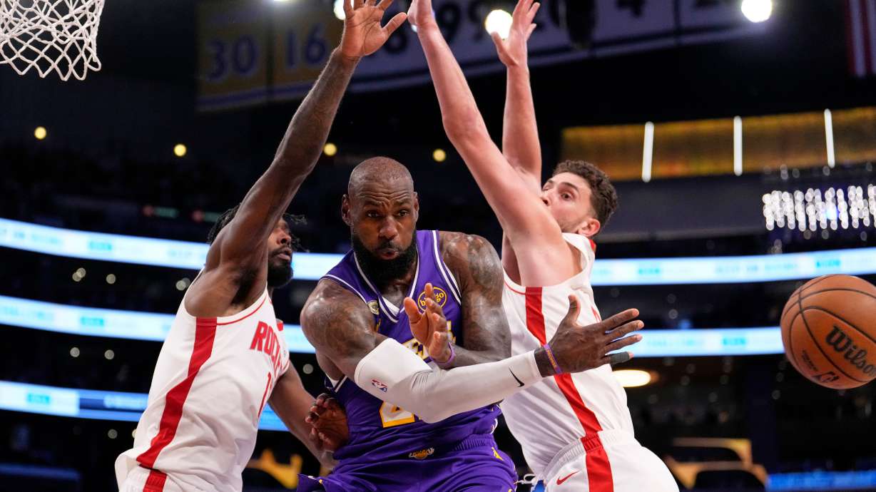 Los Angeles Lakers forward LeBron James, center, passes the ball as Houston Rockets forward Tari Eason, left, and center Alperen Sengun defend during the first half in Game 5 of a first-round NBA playoffs basketball series Wednesday, April 29, 2026, in Los Angeles.